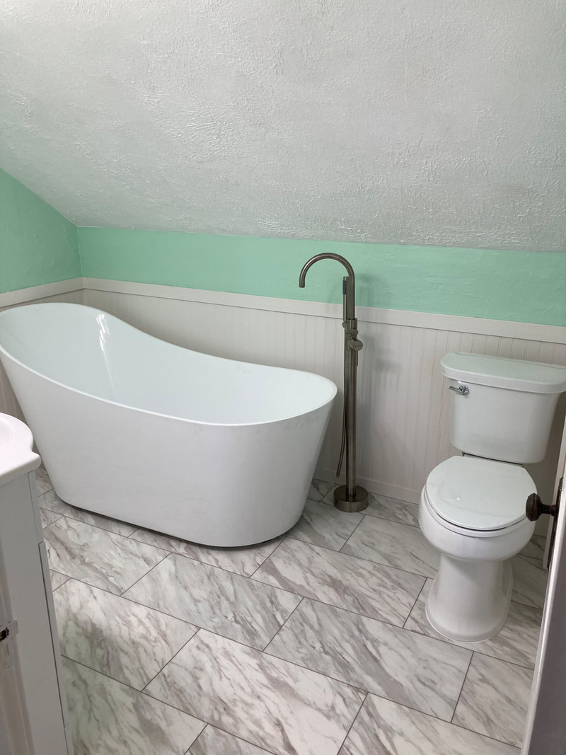 Attic bathroom remodel with freestanding tub and finished plumbing