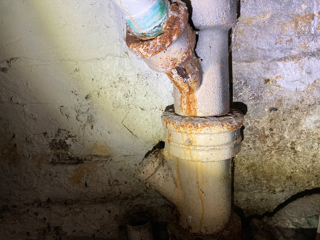 Cast-iron stack with active leak at a PVC transition joint