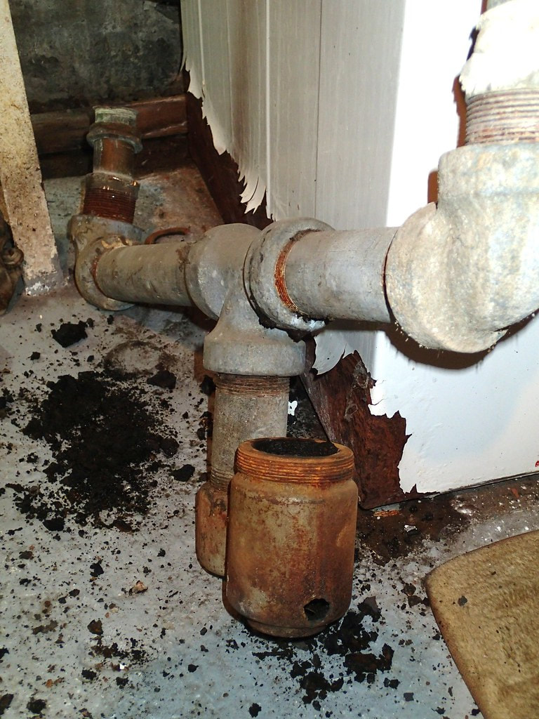 Severely rusted and failed galvanized steel pipe section